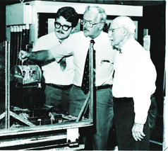 William, Nelson and George Pfundt (L to R) of General Machine Products inspect an aerial lashing machine